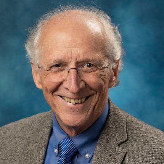 John Piper preaching a Bible-centered sermon during a Christian conference.